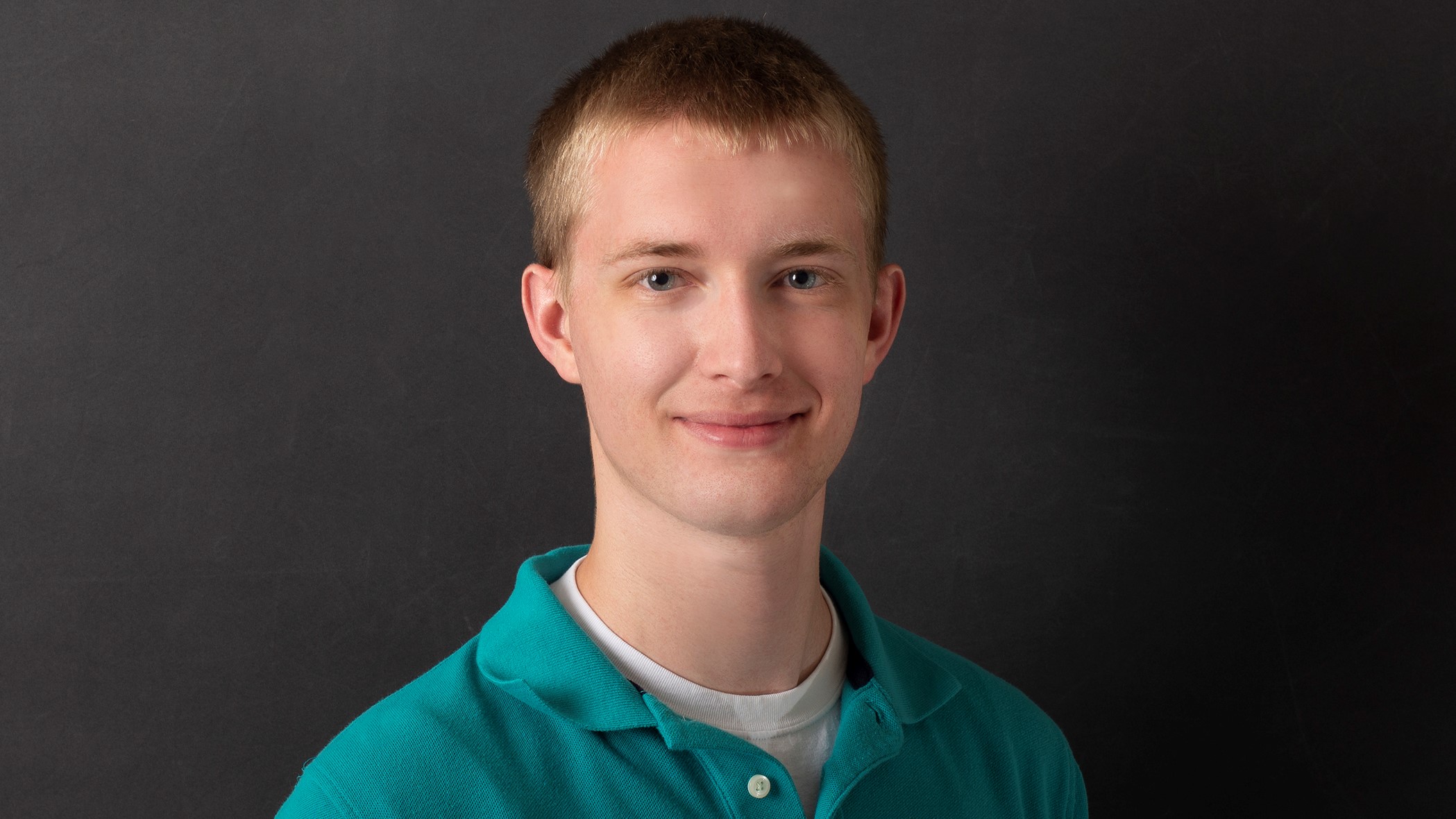 Cole Brooks, Property and Casualty Insurance Accountant at Celina Insurance Group, smiles for the camera in front of a black background.