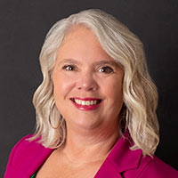 Jean LaBarge, Ohio Marketing Representative, smiles in front of a black background.