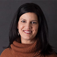 Bobbie Phillips, Tennessee Marketing Representative, smiles in front of a black background.