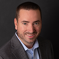 Bob Redmond, OH Marketing Representative, smiles in front of a black background.