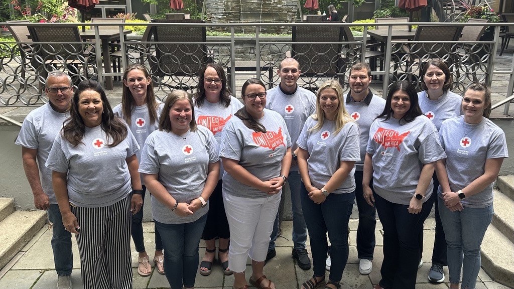 A group of people in American Red Cross Blood Donor T-shirts pose for a picture.