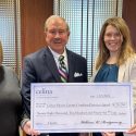 A group of Celina Insurance Group representatives hold a large check made out to the Celina-Mercer County Combined Services Appeal.